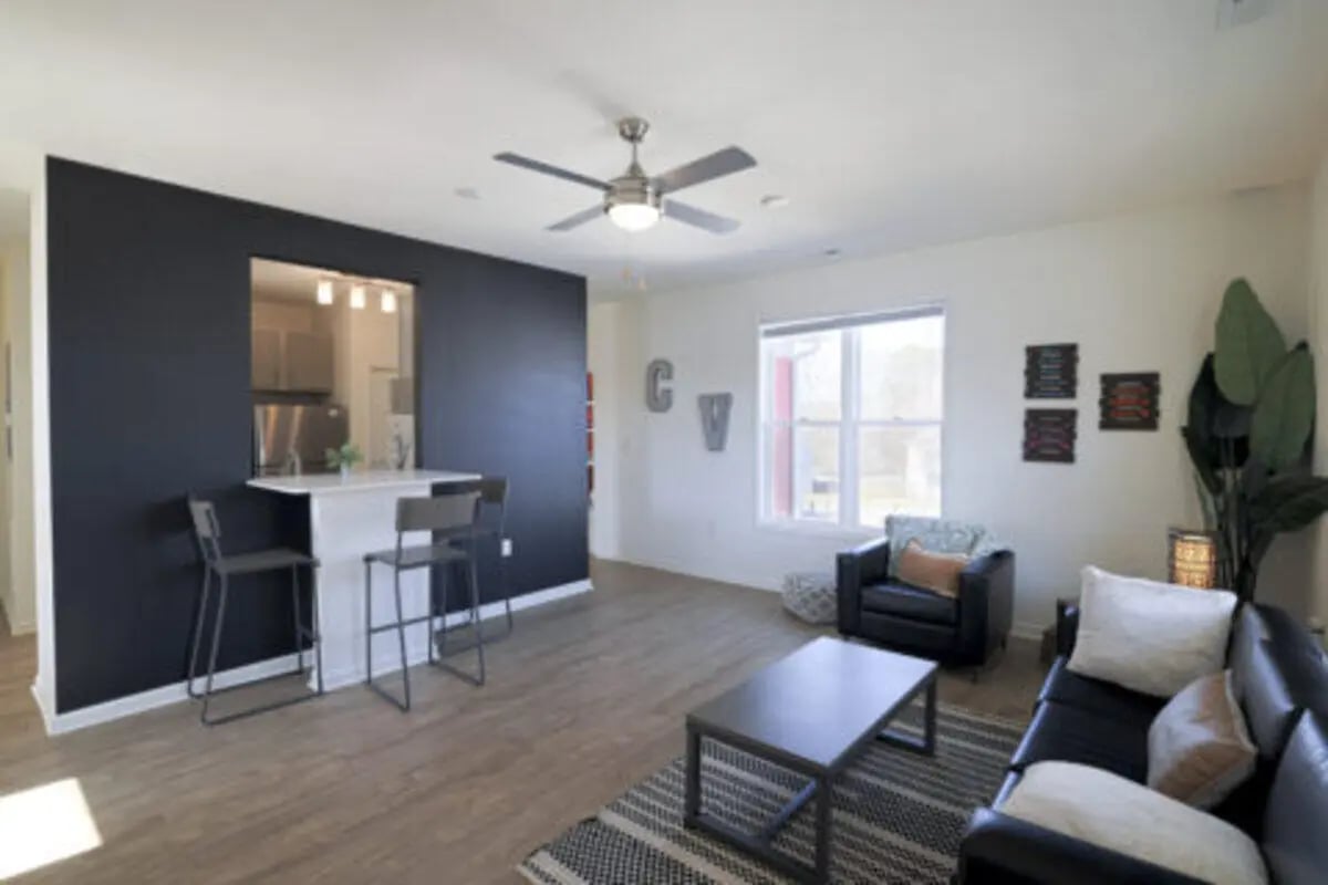 Living room with bar stools and couch living room at Clemson Village in Clemson Student Accommodation