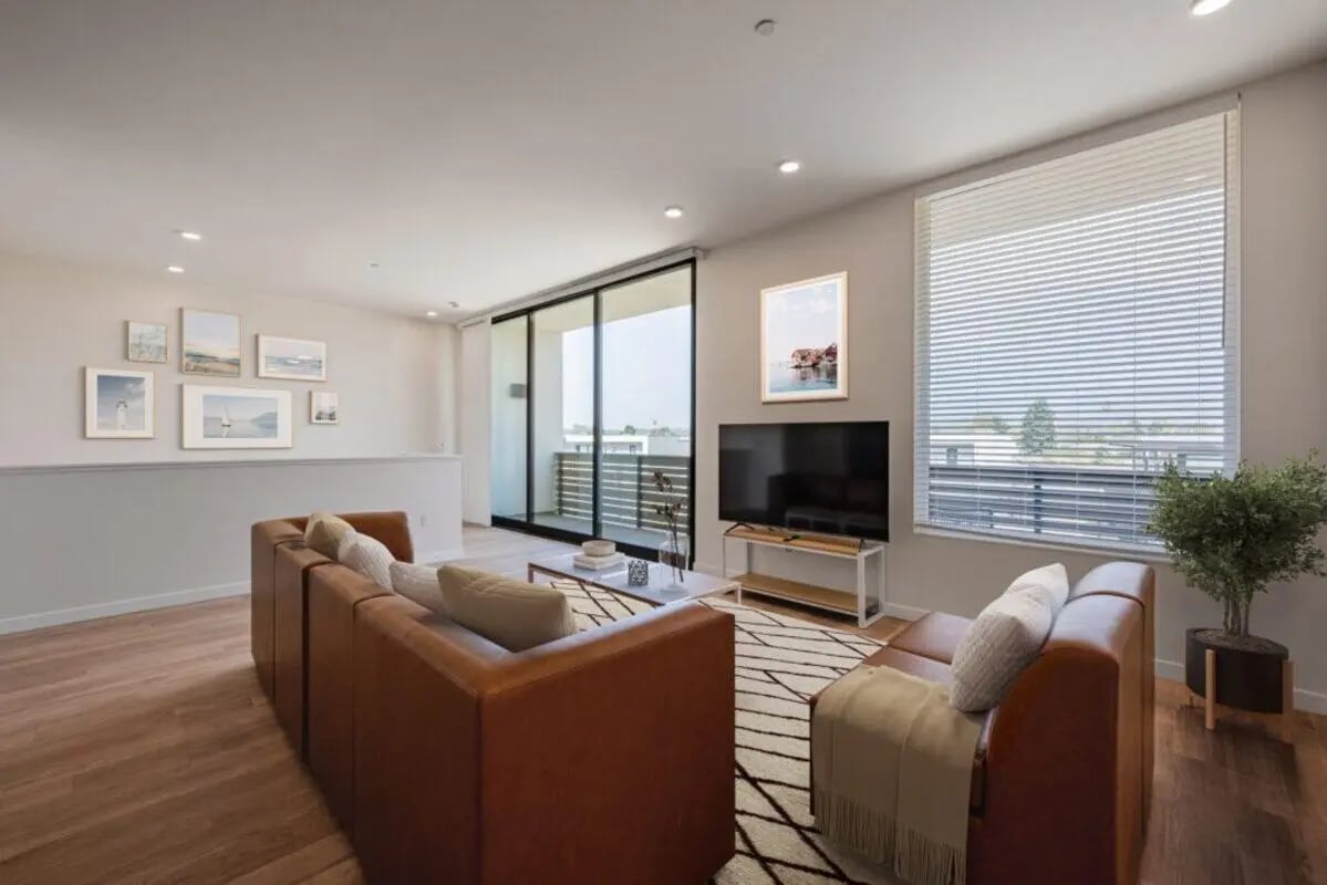 Brown sofas coffee table TV artwork living room at The Cove Santa Barbara in Isla Vista Student Accommodation