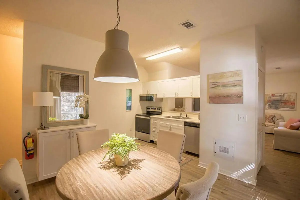 Oval table plant fire extinguisher kitchen dining room at The French Quarter Apartments in Auburn Student Accommodation