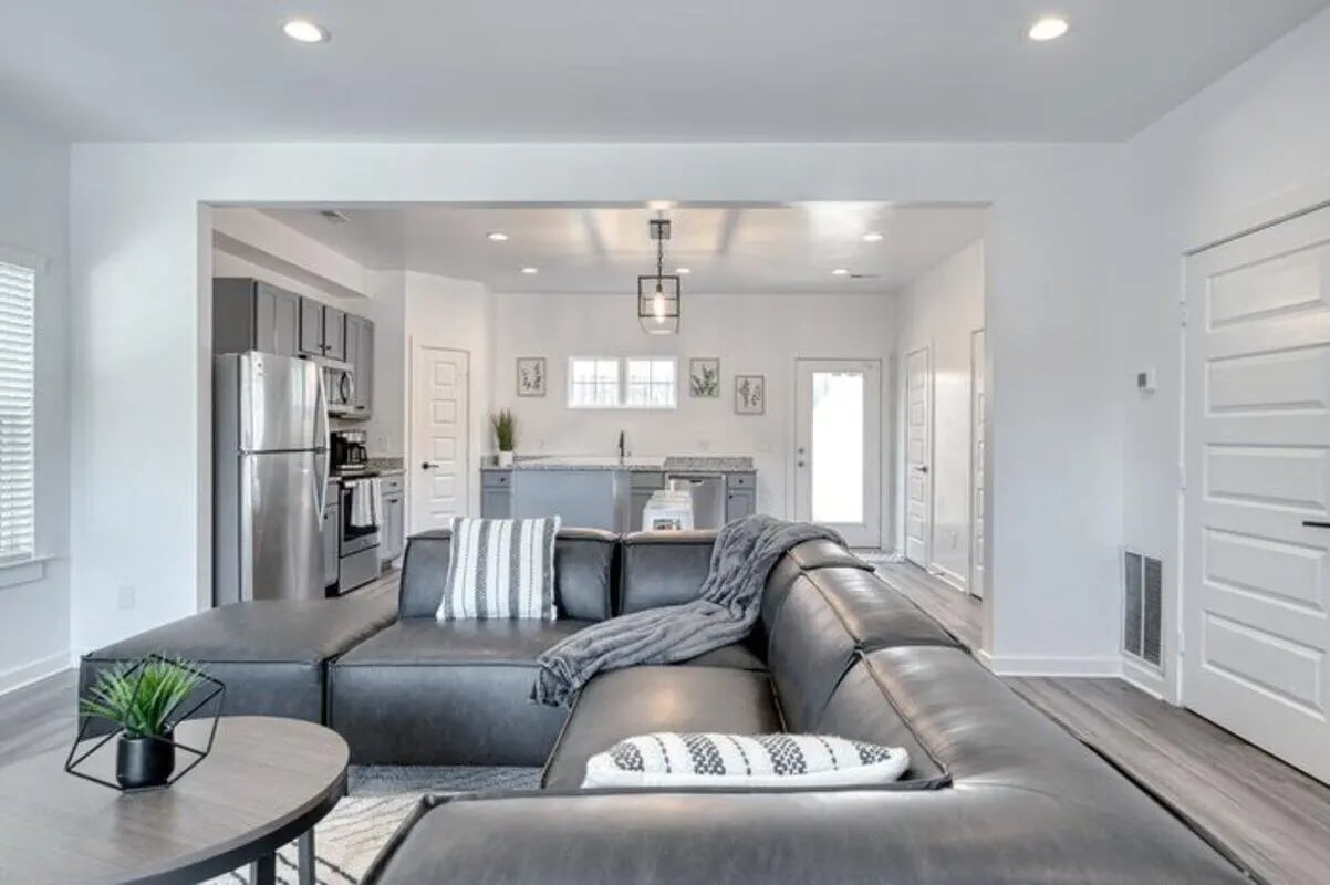 Modern sectional sofa and open kitchen living room at Haven Blacksburg in Blacksburg Student Accommodation
