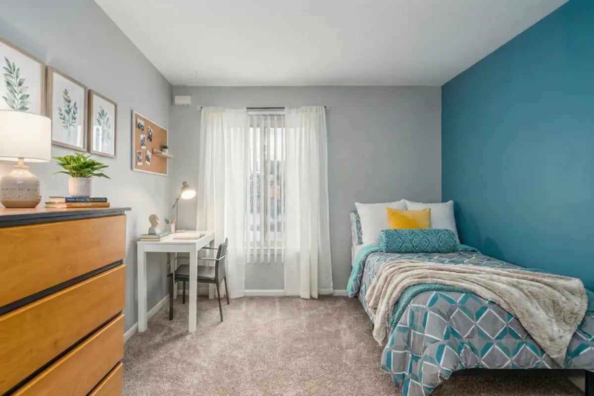 Bed desk lamp dresser plant art and desk bedroom at Campus Hill Apartments