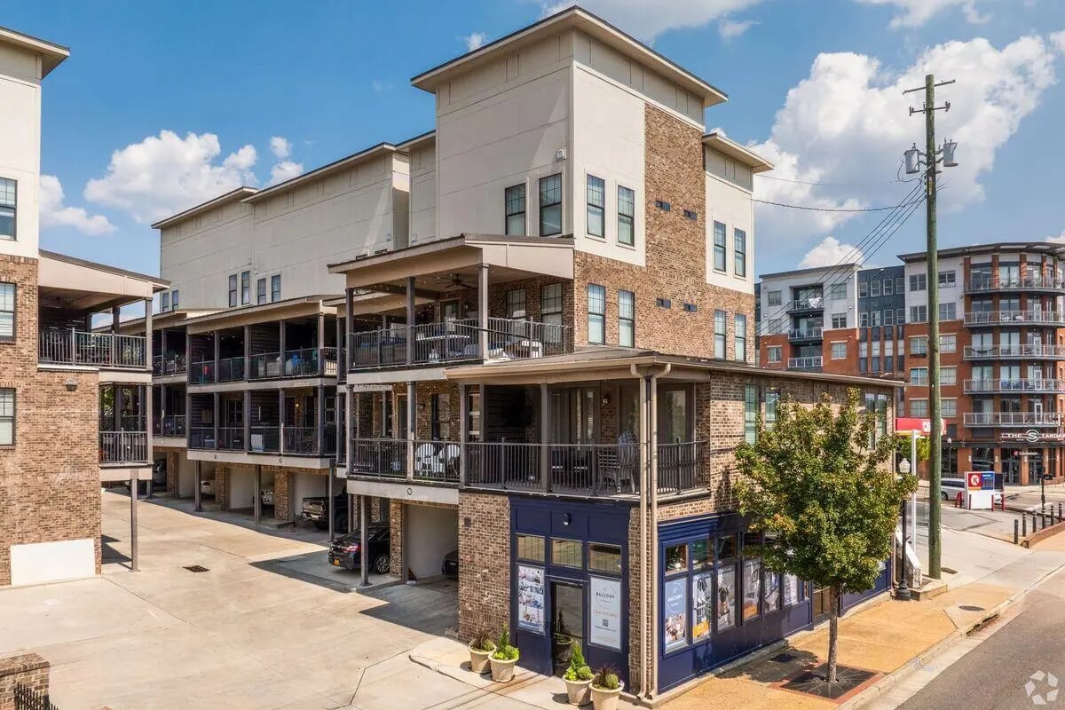Brick buildings with balconies and parking exterior at The Balcony Auburn | Student Living in Auburn Student Accommodation