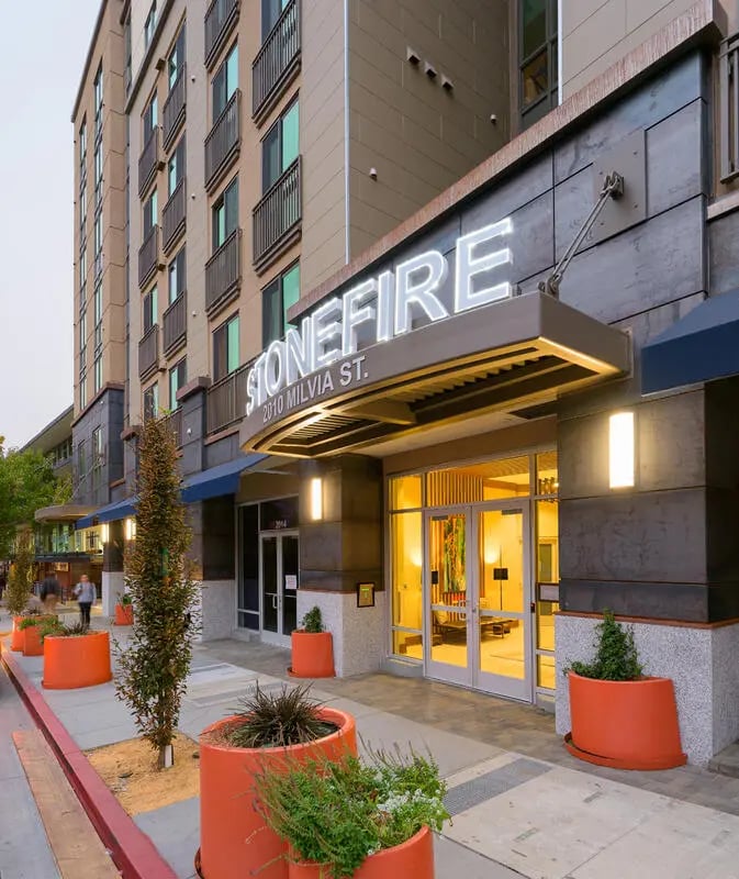 Stonefire building entrance with orange planters exterior at Stonefire Berkeley in Berkeley Student Accommodation