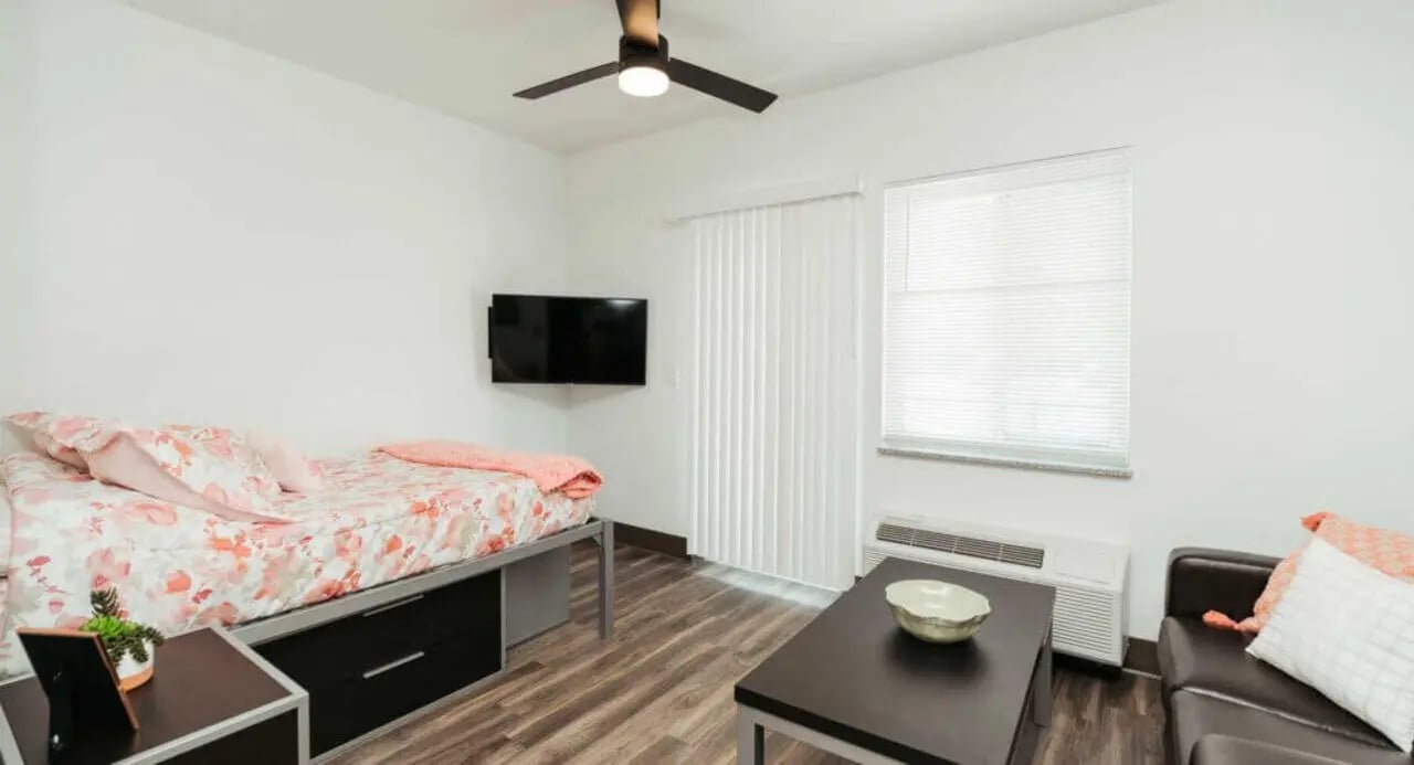 Bed TV table and couch living room at WestEdge in Springfield Student Accommodation