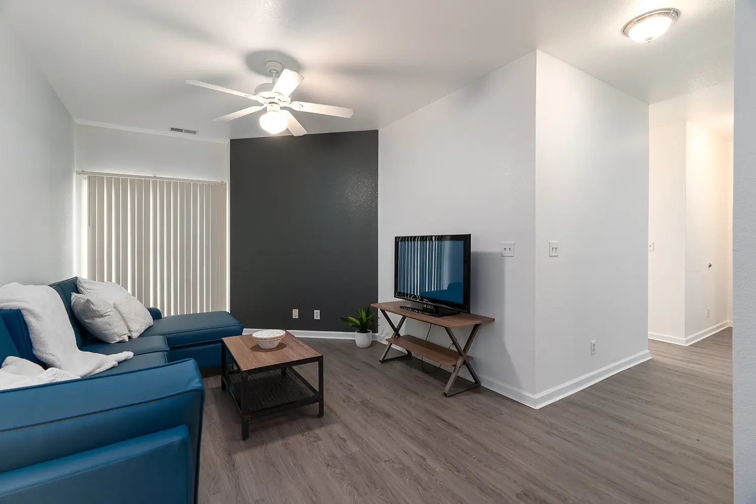 Blue sofa television and coffee table living room at Station 21 in West Lafayette Student Accommodation