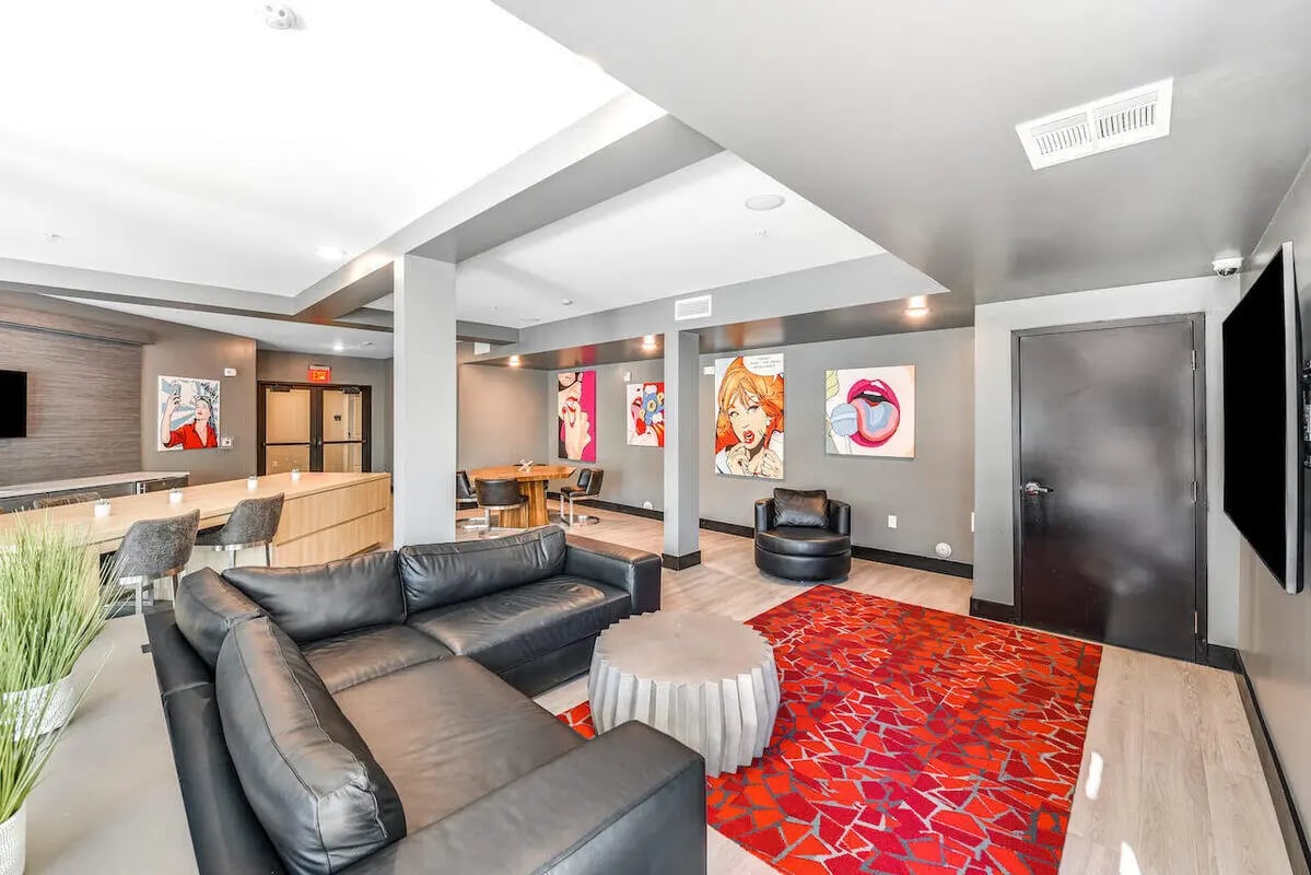 Black leather couch red rug living room at Park Place Tempe in Tempe Student Accommodation