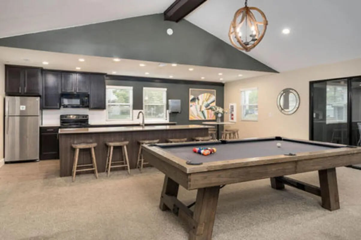 Pool table kitchen with stools game room at Arbor Glen Apartments in East Lansing Student Accommodation