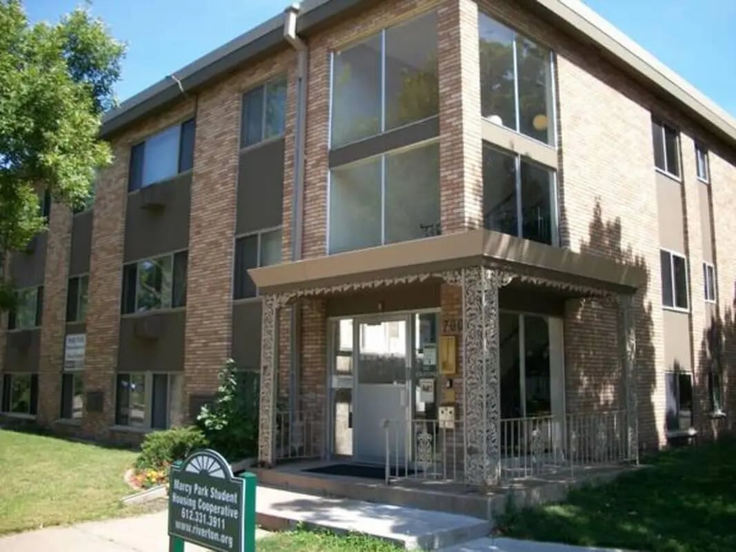 Brick building with large windows entrance exterior at Marshall Student Housing Co-op in Minneapolis Student Accommodation