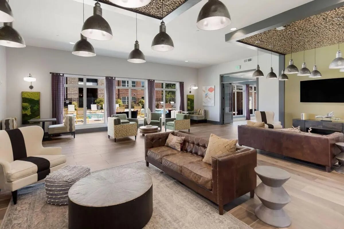 Leather couches armchairs coffee tables rugs living room at Watercress Tuscaloosa in Tuscaloosa Student Accommodation
