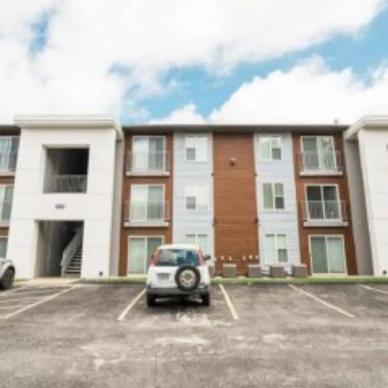 Apartment building with parking and car exterior at MadisonVue Apartments in Springfield Student Accommodation