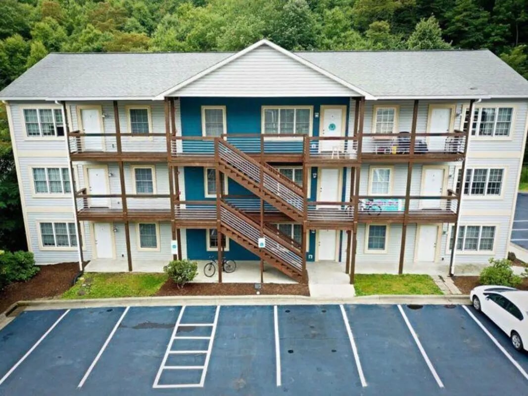 Apartment building with balconies and stairs exterior at Highland Woods Apartments of Boone in Boone Student Accommodation