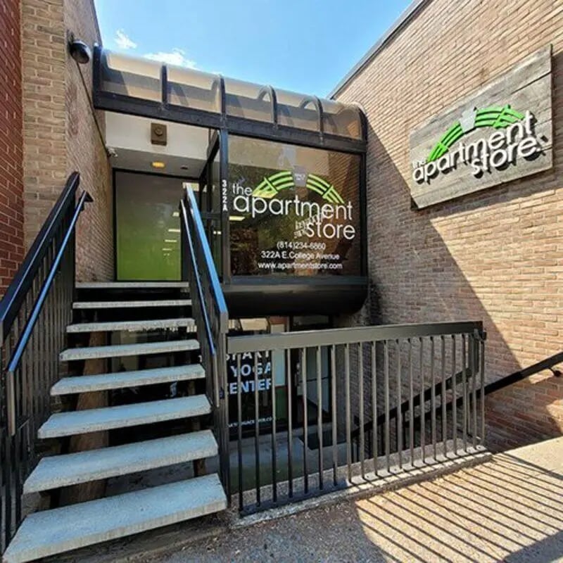 Building entrance with stairs and apartment store sign Exterior at The Apartment Store in State College Student Accommodation