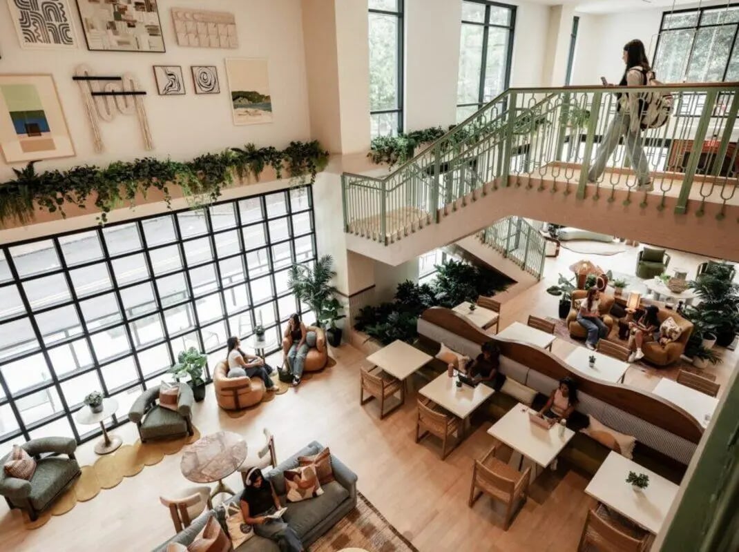 Modern lounge area with seating tables and plants living room at Rambler Atlanta Apartments in Atlanta Student Accommodation