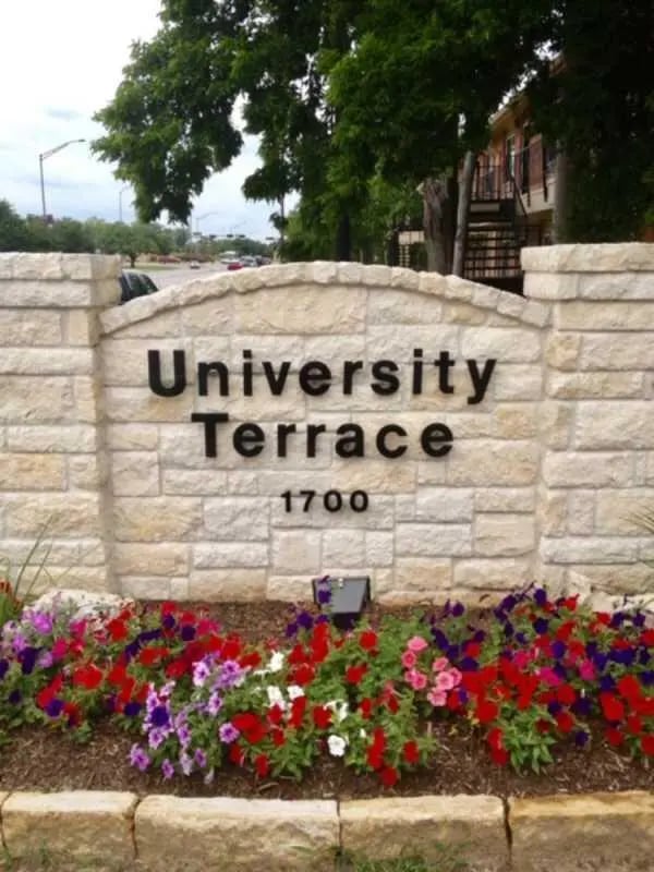 University Terrace sign with colorful flowers exterior at University Terrace Apartments in State College Student Accommodation