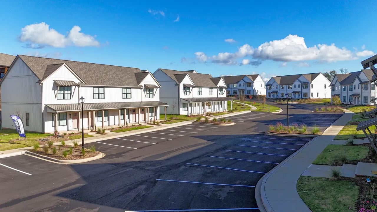White townhouses with parking lot exterior at Tiger Properties of Clemson, LLC in Clemson Student Accommodation