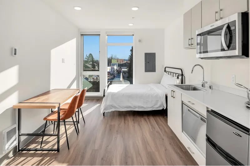Bed desk kitchen counter and appliances studio apartment at Thirty One Apartments in Seattle Student Accommodation
