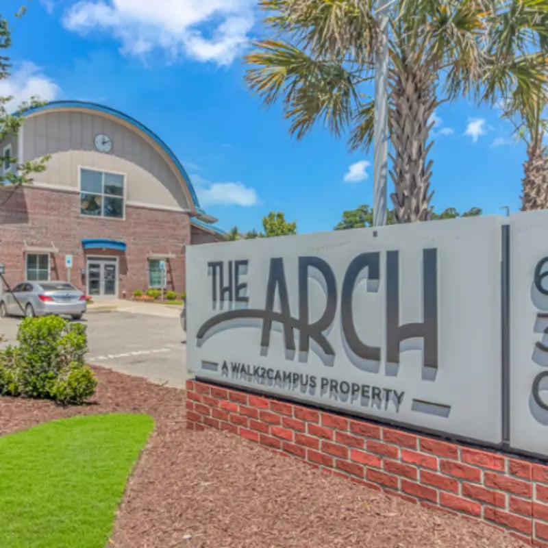 The Arch sign building and palm trees exterior at The Ascent in Conway Student Accommodation