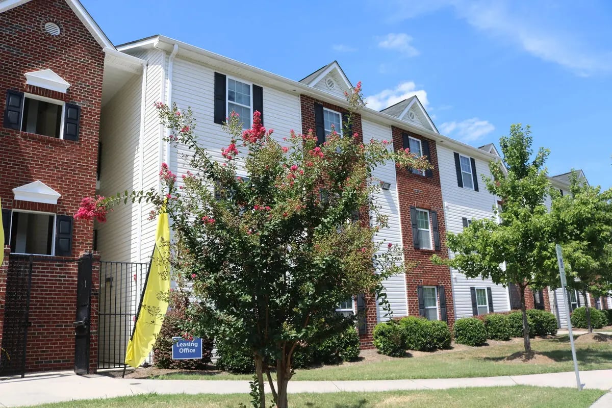Apartment buildings with brick and siding exterior exterior at Campus East Apartments in Greensboro Student Accommodation