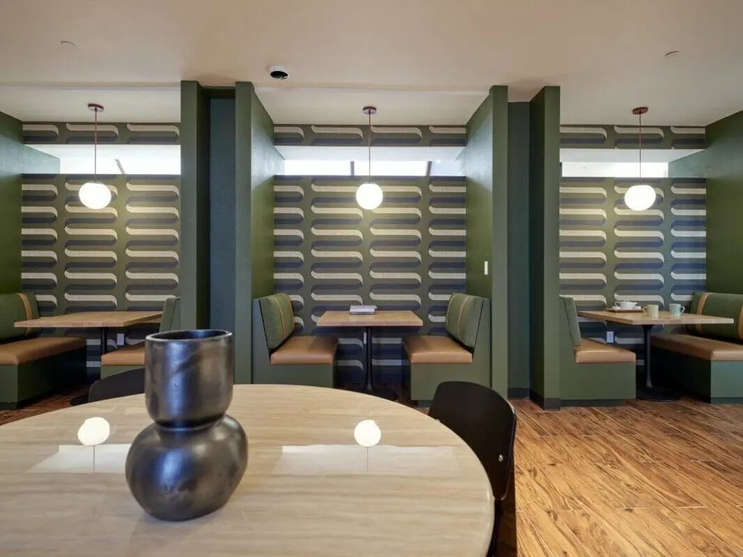 Booth seating with tables and pendant lights common area at Abigail Court in Gresham Student Accommodation