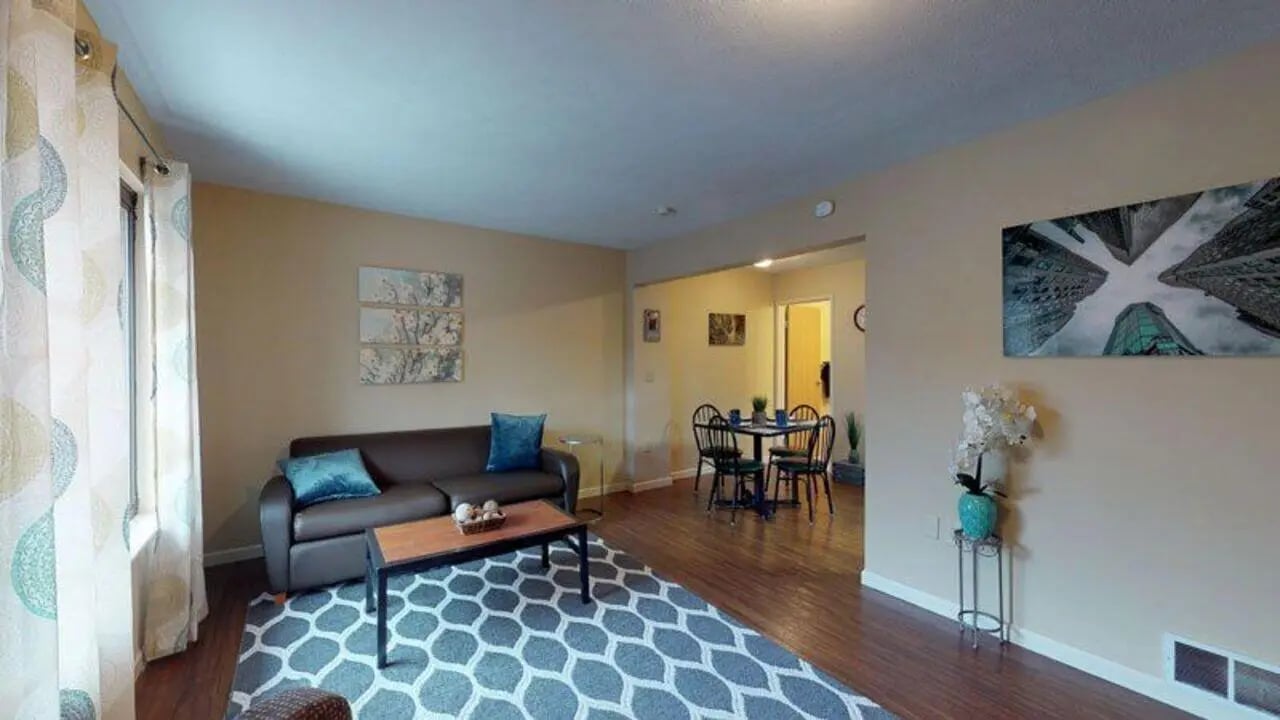 Sofa dining table patterned rug living room at Bayit Edinboro in Edinboro Student Accommodation
