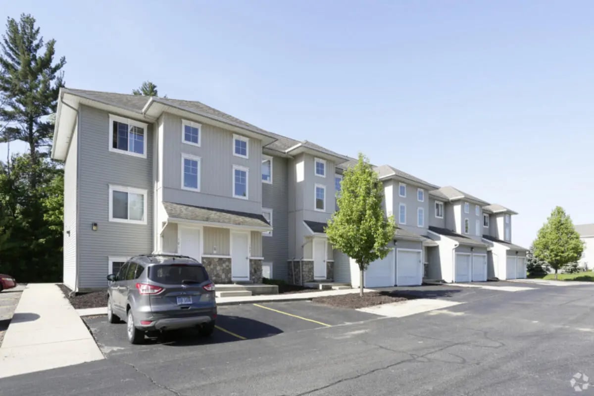 Townhouses with garages and car exterior at Conifer Creek Townhomes in Allendale Student Accommodation
