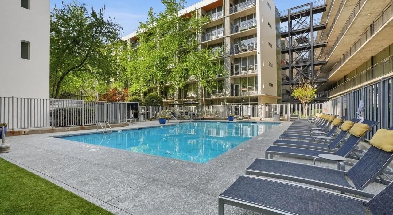 Pool lounge chairs building exterior and pool Playing area at 1016 Lofts in Atlanta Student Accommodation