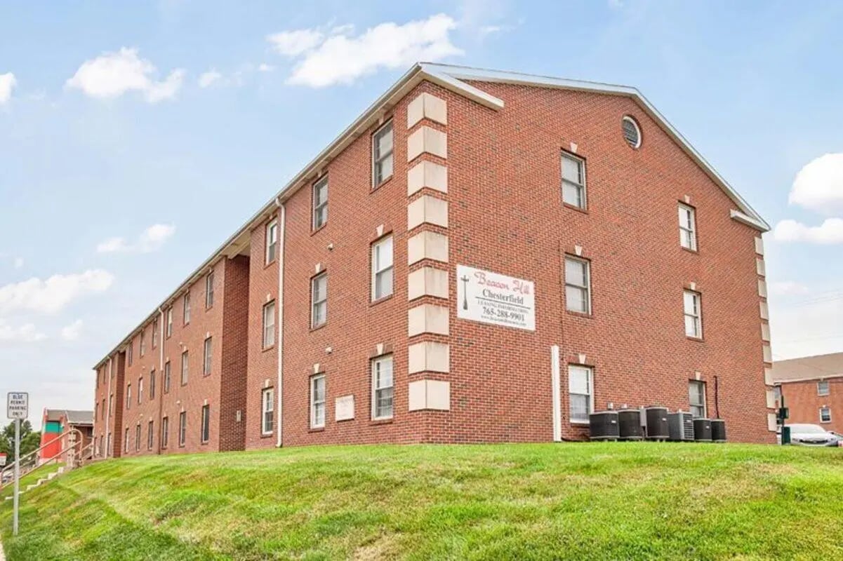 Red brick building with many windows exterior at Chesterfield Apartments Muncie in Muncie Student Accommodation