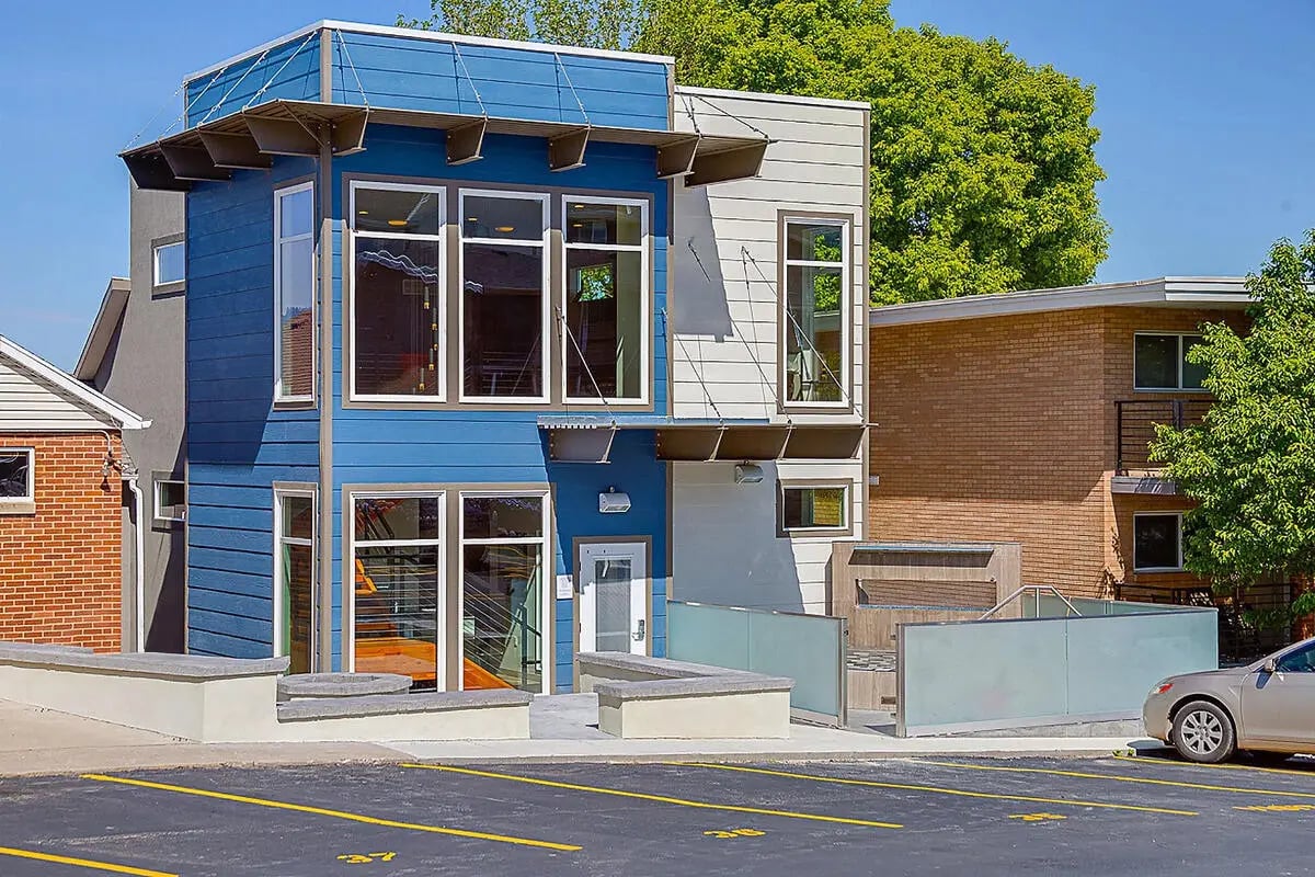 Modern blue and grey building with large windows exterior at Alpine Flats (NOW UNIVERSITY LANDING) in Logan Student Accommodation