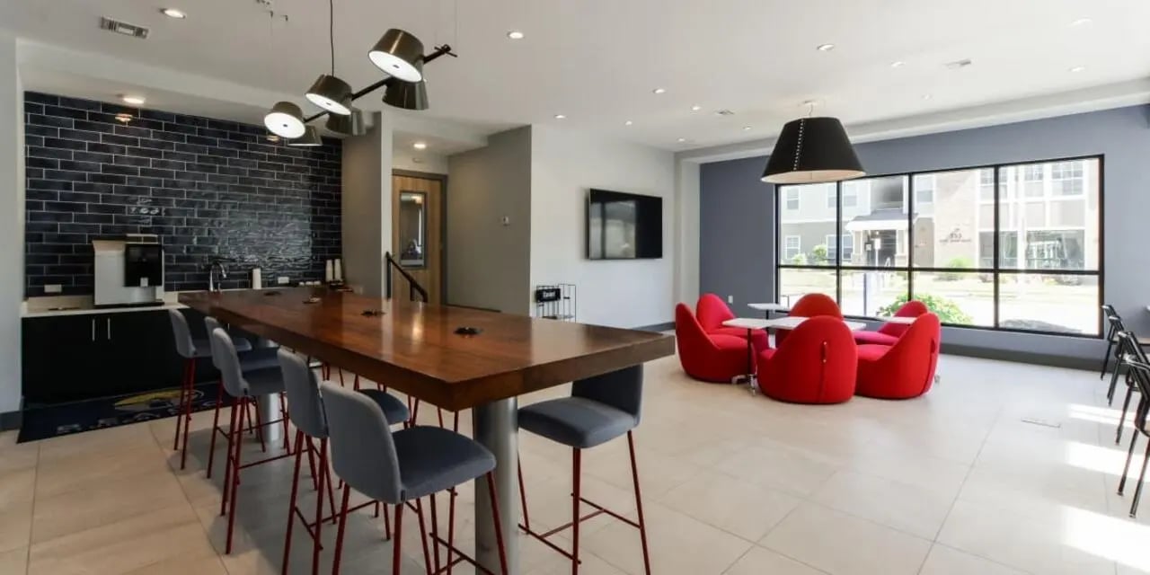 Communal lounge area with coffee maker and seating at Beacon Springfield in Springfield Student Accommodation