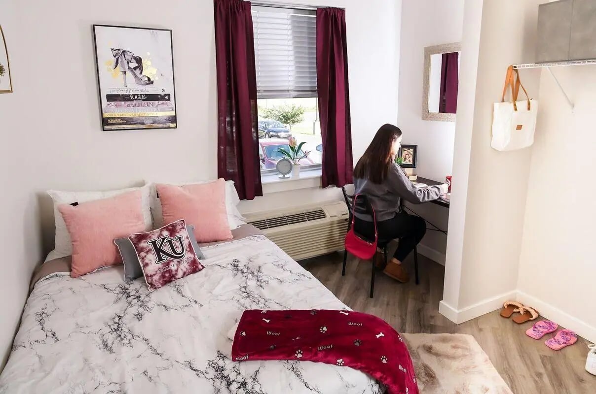 Bed with pink pillows study desk with student bedroom at Advantage Point Student Apartments in Kutztown Student Accommodation