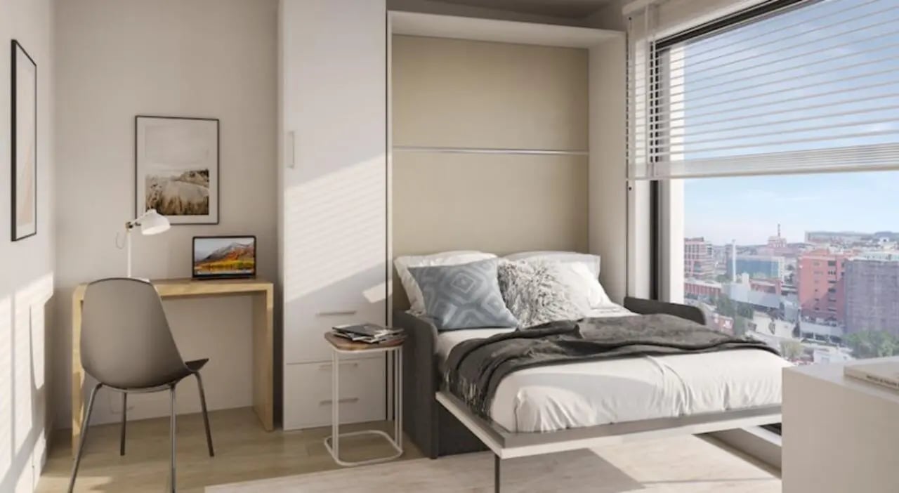Desk bed and city view student accommodation bedroom at 7 INK in Boston Student Accommodation