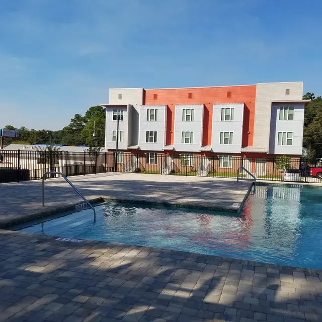 Modern apartment building with pool exterior at Arive850 in Tallahassee Student Accommodation