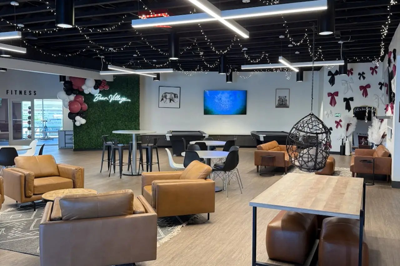 Leather chairs tables pool tables lounge area at Bear Village Apartments in Springfield Student Accommodation