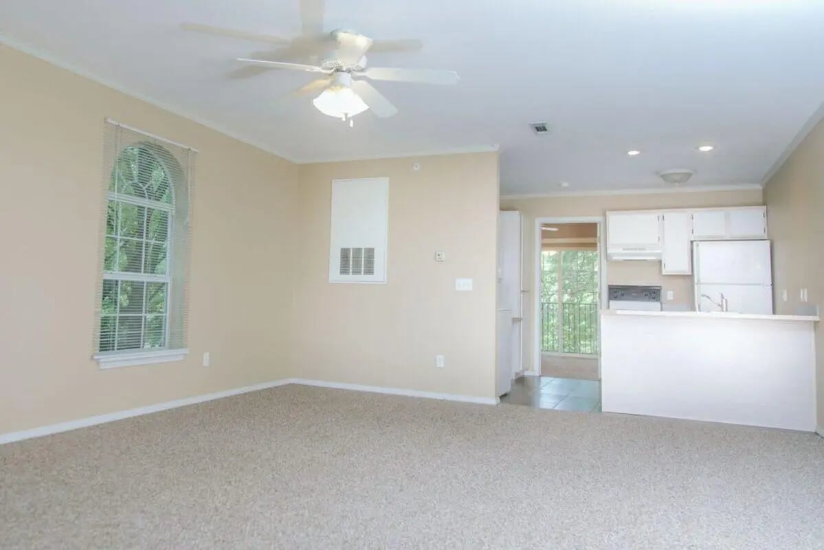 Carpeted room kitchen area and balcony living room at Campus Crossing Apartments in Greensboro Student Accommodation