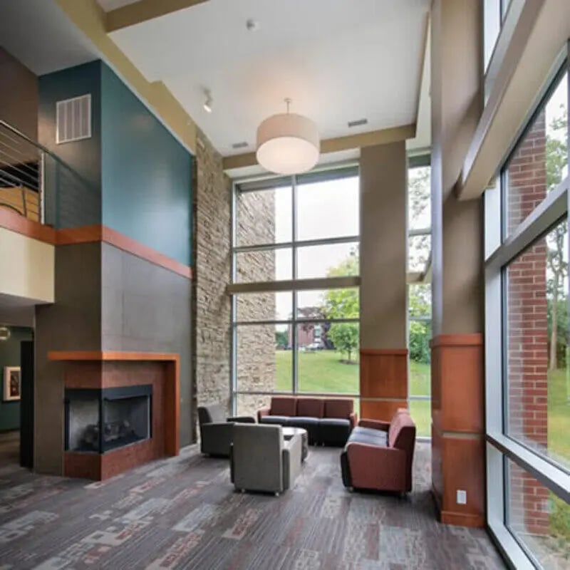 Fireplace sofas chairs modern lounge living room at Crosswalk Commons in West Lafayette Student Accommodation