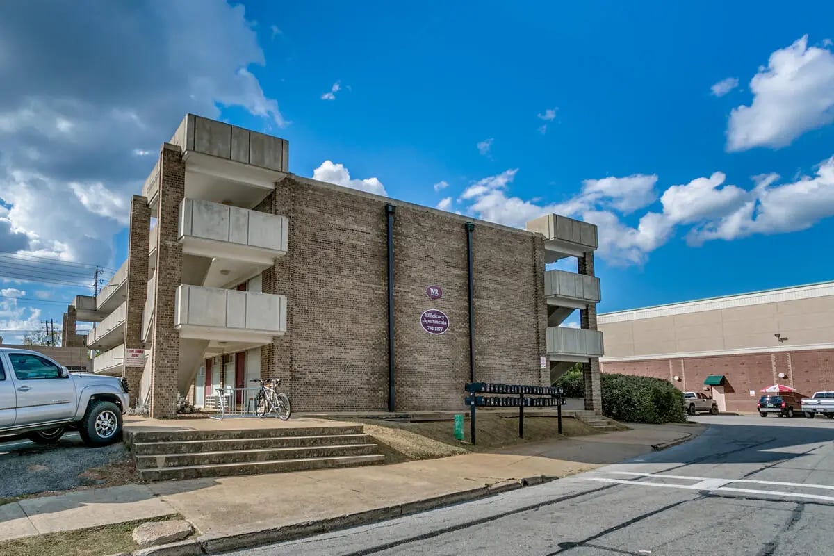 Brick building balconies stairs bicycle exterior at Cobblestone Court Apartments in Tuscaloosa Student Accommodation