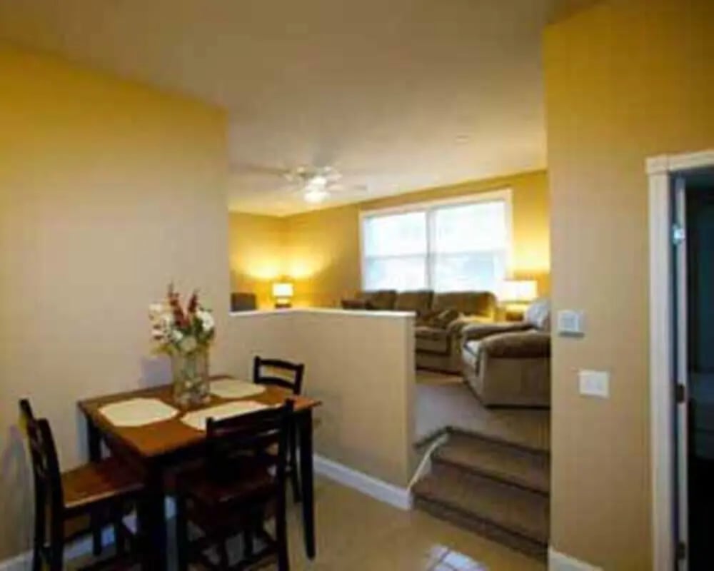 Dining table and chairs with living room living room at Cornerstone Properties Cortland, LLC in Cortland Student Accommodation