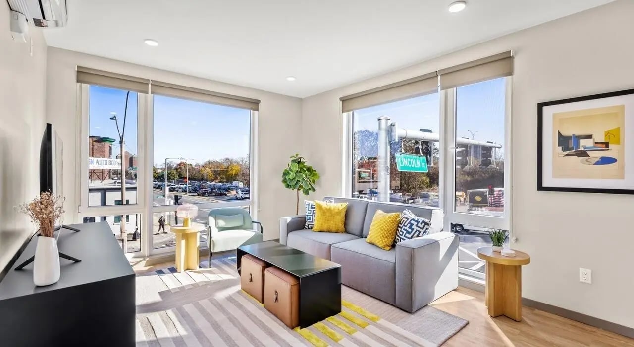 Grey sofa yellow pillows modern living room living room at 525 Linc in Boston Student Accommodation