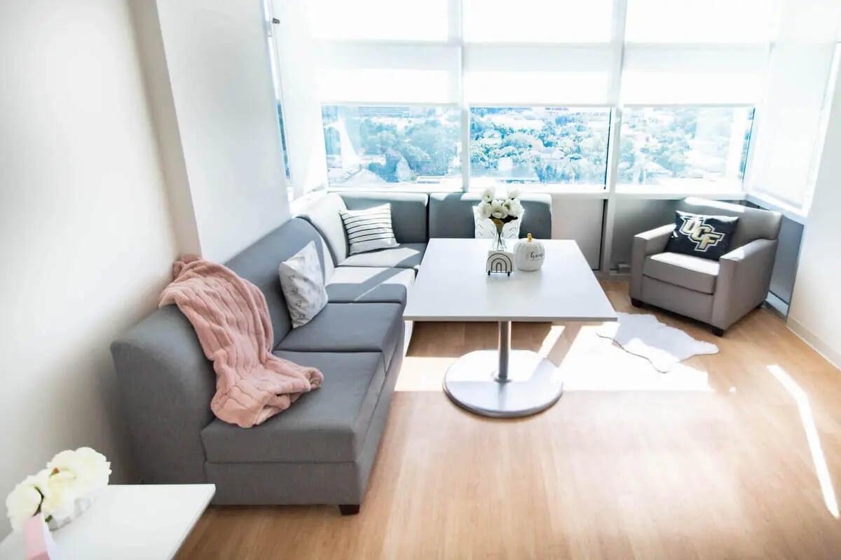 Sectional couch table chair and rug living room at UnionWest Student Living in Orlando Student Accommodation