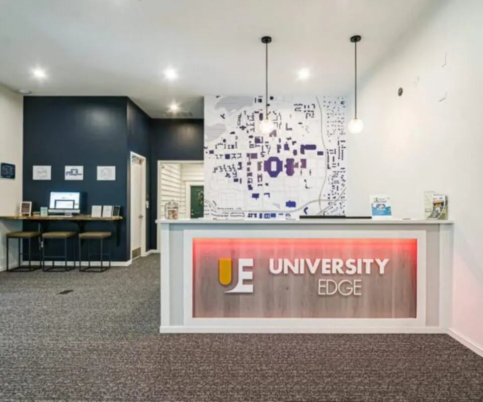 Reception desk with map and computer area lobby at University Edge South Bend in South Bend Student Accommodation