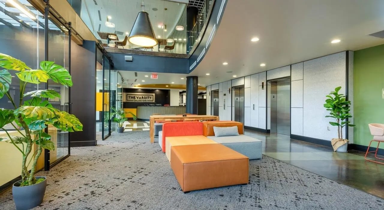 Modern lobby seating with plants elevators and reception area at The Varsity College Park in College Park Student Accommodation