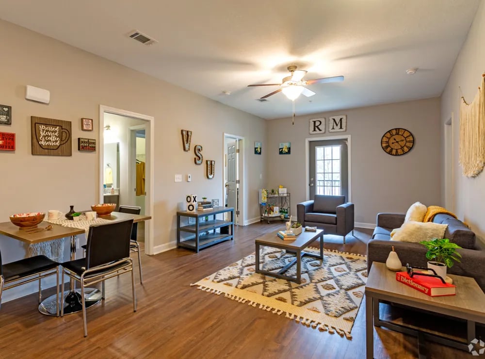 Dining table sofa chairs coffee table living room at Remerton Mill Apartments in Valdosta Student Accommodation