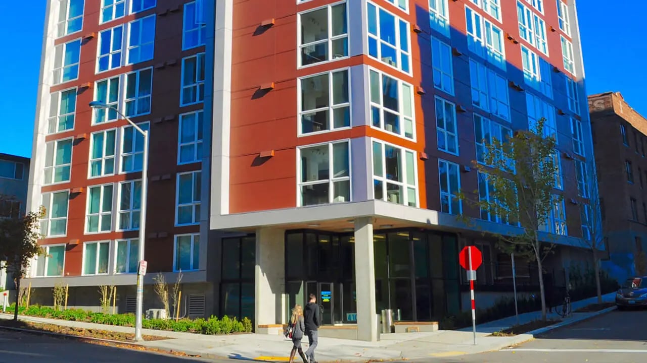 Modern building with many windows exterior at NORA Apartments in Seattle Student Accommodation