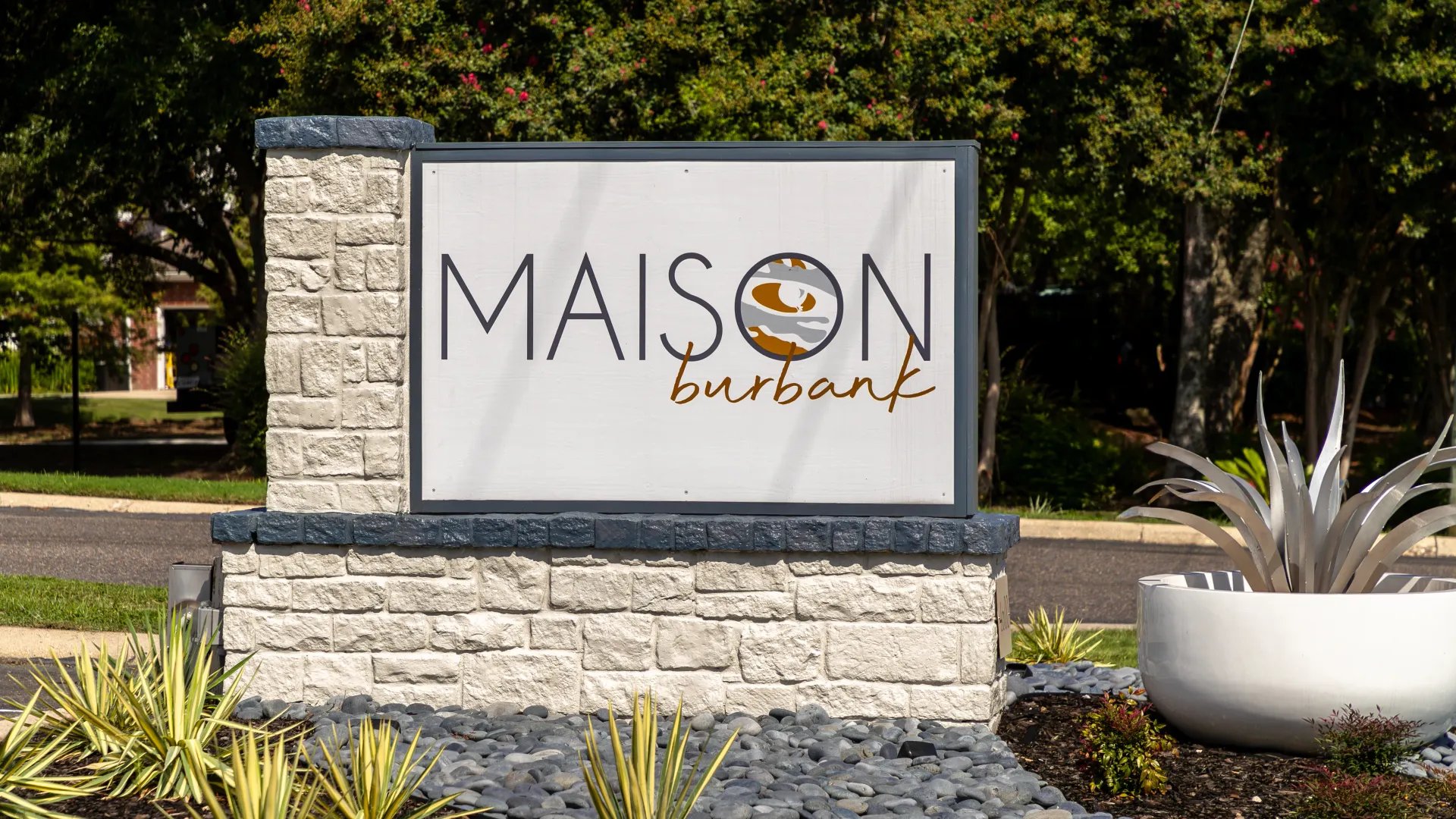 Maison Burbank sign with stone pillars exterior at Maison Burbank in Baton Rouge Student Accommodation