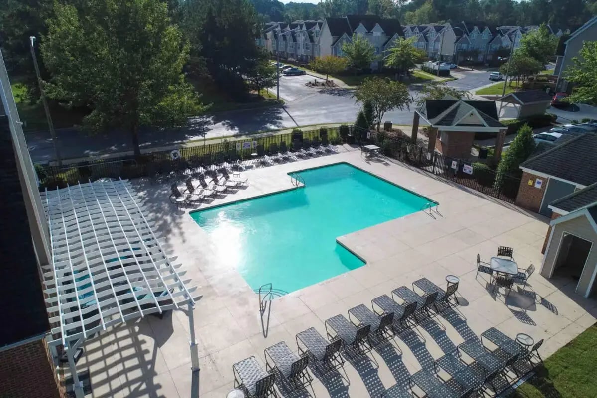Pool lounge chairs and tables exterior living area at Carolina Creek in Greenville Student Accommodation