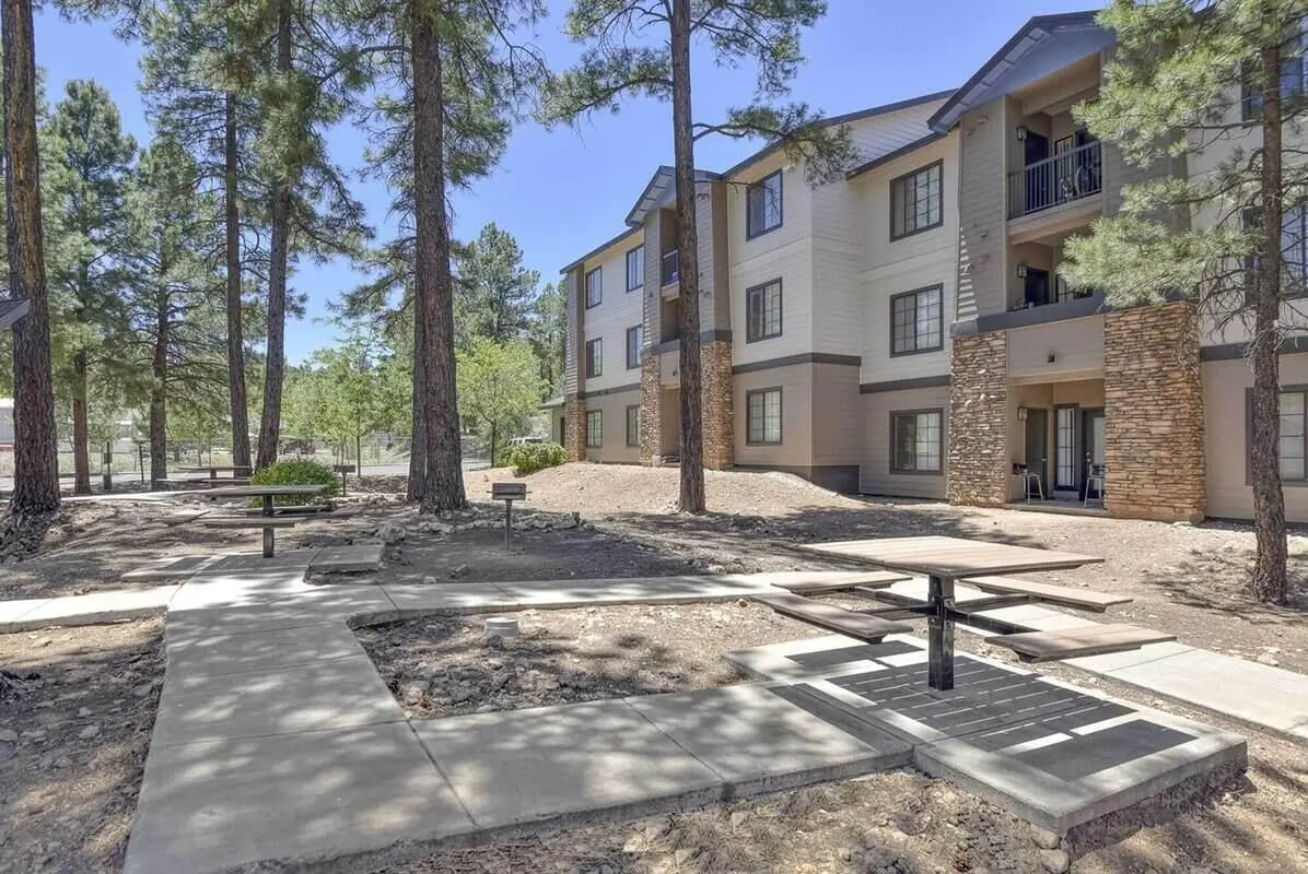 Picnic tables near apartment building exterior at Clear Creek Village Apartments in Flagstaff Student Accommodation