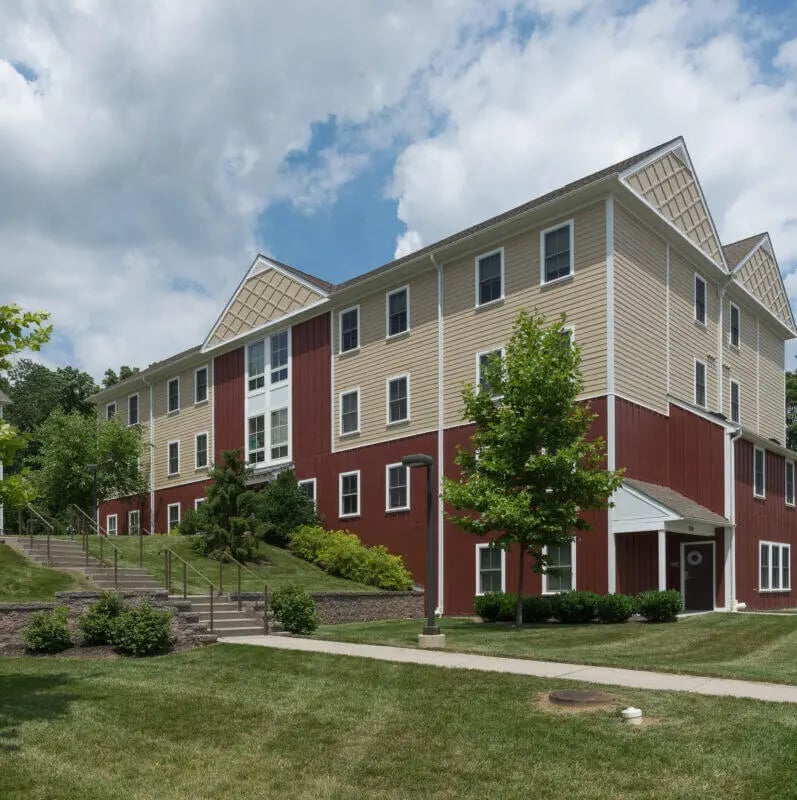 Student housing building with stairs and lawn exterior at East Village at WCU in West Chester Student Accommodation