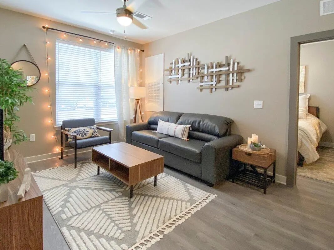Sofa chair coffee table rug living room at Cedar Pointe Apartments in Blacksburg Student Accommodation