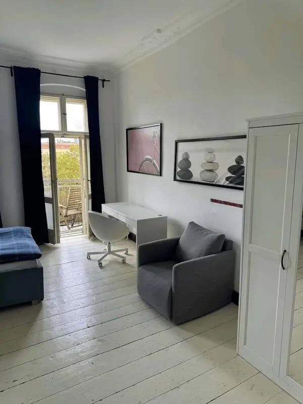 Desk chair armchair wardrobe painting bedroom at Apartment in Krossener Str., 10245 Berlin-Bezirk Friedrichshain-Kreuzberg, Germany in Berlin Student Accommodation