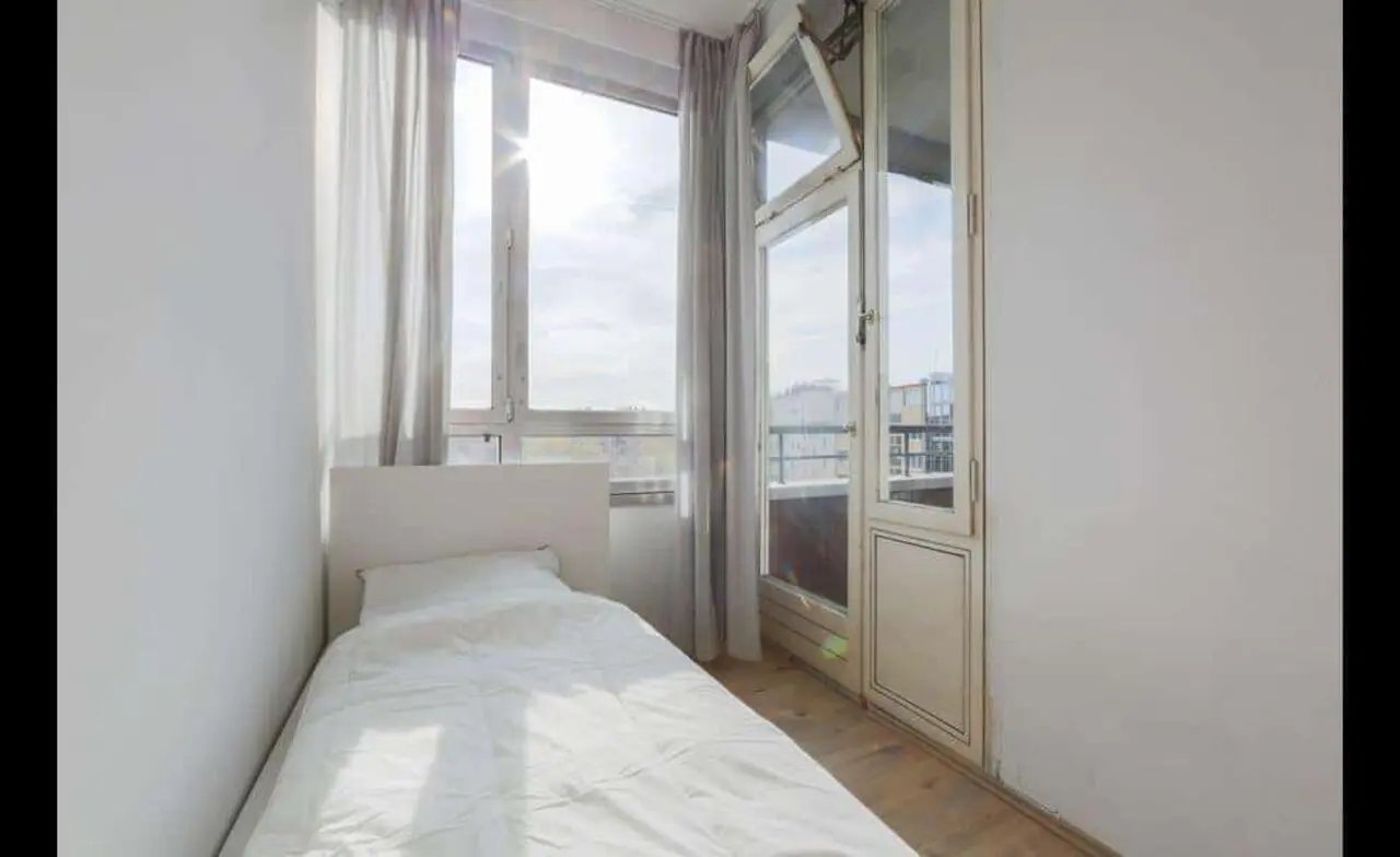 Single bed by window with curtains bedroom at Room in Bismarckstraße 106, 10625 Berlin, Germany in Berlin Student Accommodation